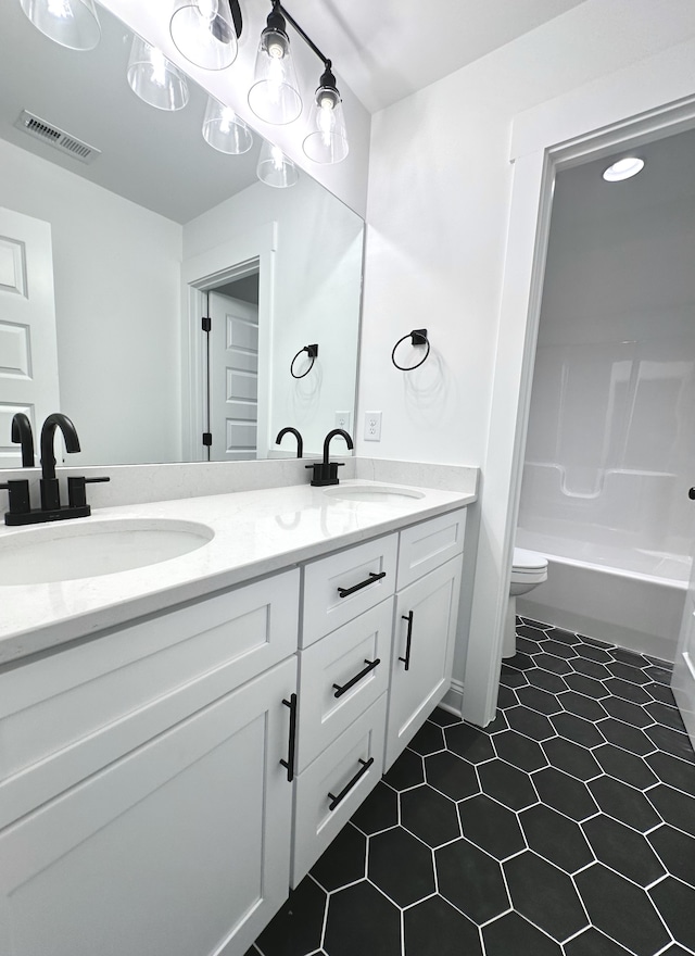 full bathroom with tile patterned floors, shower / bathing tub combination, vanity, and toilet