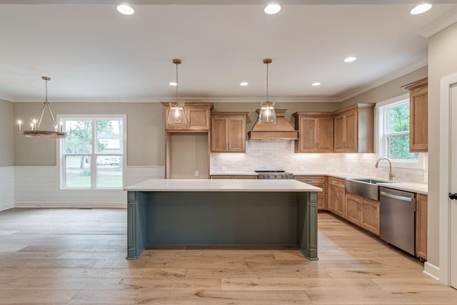 kitchen with pendant lighting, dishwasher, premium range hood, a center island, and light hardwood / wood-style floors