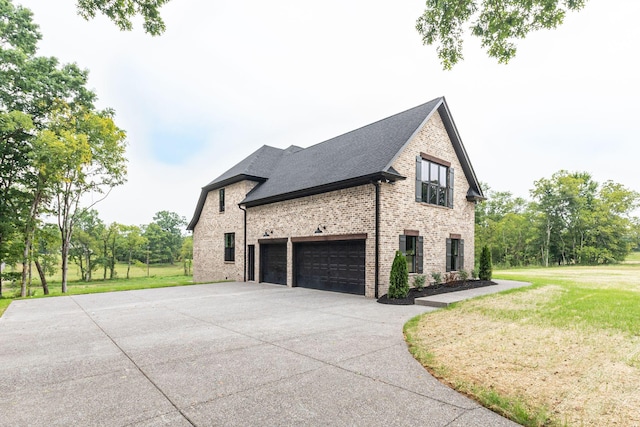 view of property exterior featuring a yard and a garage