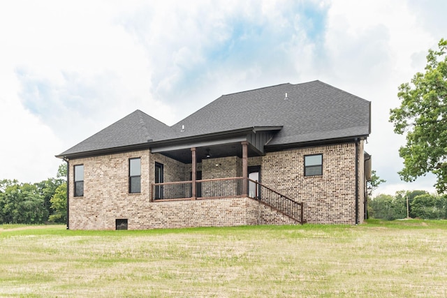 rear view of house with a yard and ceiling fan