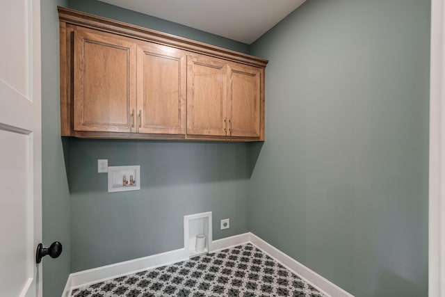 laundry area with electric dryer hookup, hookup for a washing machine, and cabinets