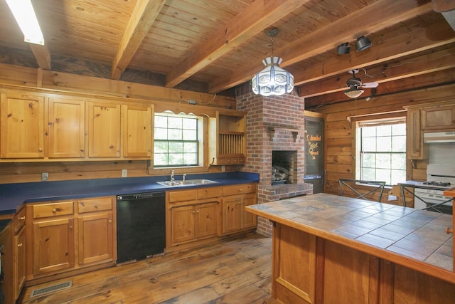 kitchen with tile countertops, dishwasher, beamed ceiling, a healthy amount of sunlight, and white range with gas stovetop