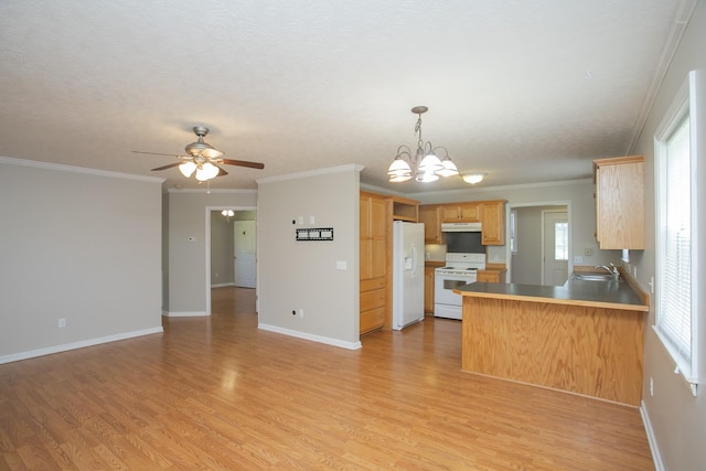 kitchen with light brown cabinets, kitchen peninsula, crown molding, white appliances, and ceiling fan with notable chandelier