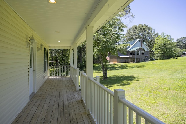 deck with a porch and a lawn