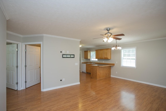 unfurnished living room with ceiling fan with notable chandelier, light wood-type flooring, ornamental molding, and sink