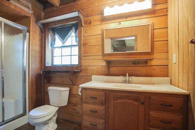 bathroom with vanity, a shower with door, and wooden walls