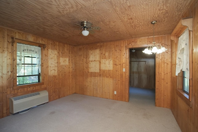 carpeted spare room with a wall mounted air conditioner, ceiling fan with notable chandelier, wood walls, and wood ceiling