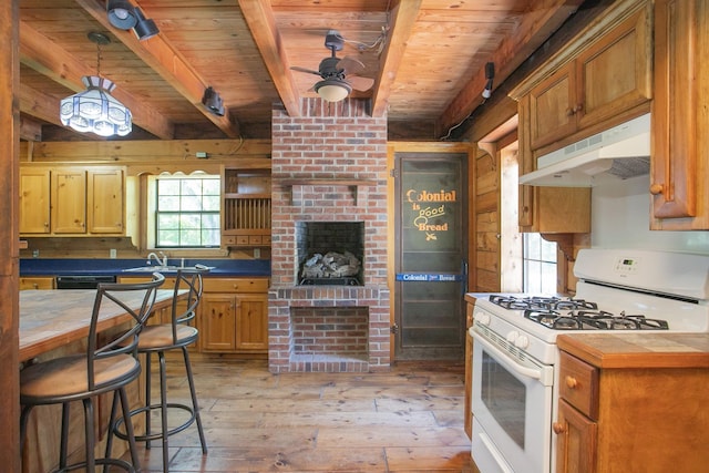 kitchen with wooden ceiling, ceiling fan, light wood-type flooring, white gas range, and beamed ceiling