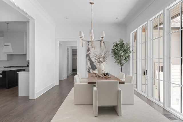 dining area with ornamental molding, a healthy amount of sunlight, and dark wood-type flooring