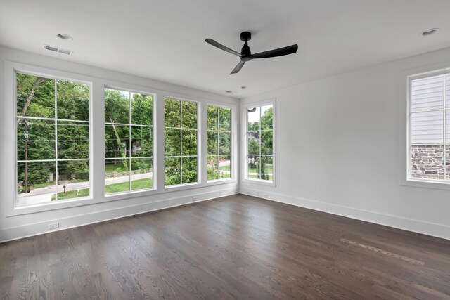 unfurnished room featuring ceiling fan and dark hardwood / wood-style flooring