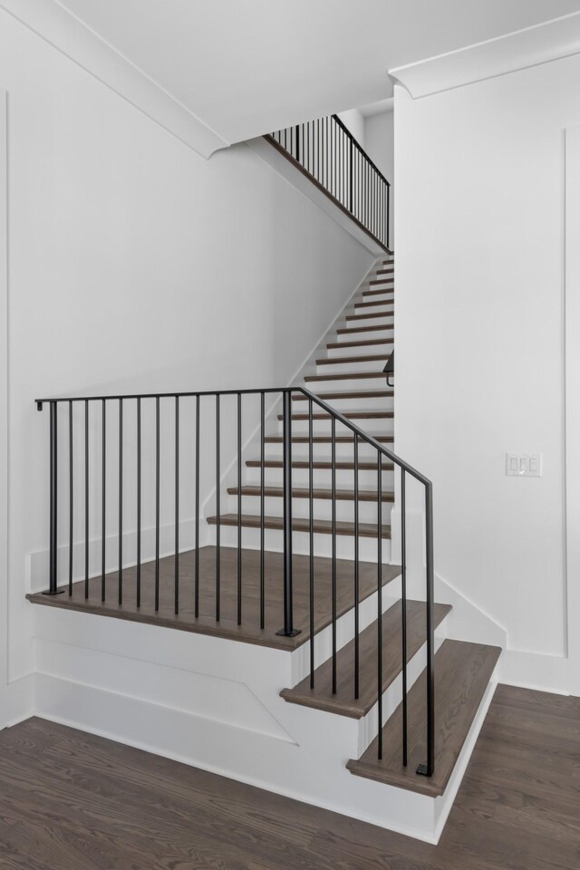 stairway featuring dark hardwood / wood-style flooring