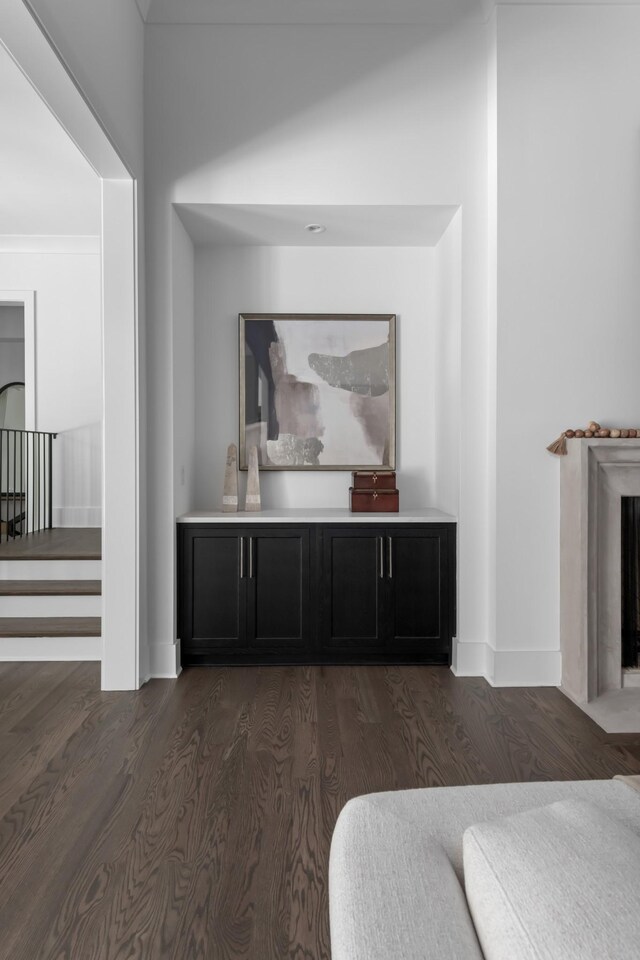 bar featuring dark wood-type flooring and lofted ceiling