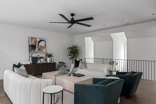 living room featuring ceiling fan and dark hardwood / wood-style flooring