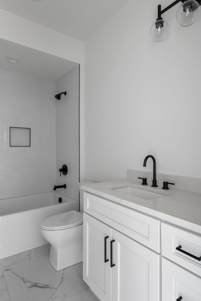 full bathroom with tiled shower / bath, tile flooring, toilet, and vanity