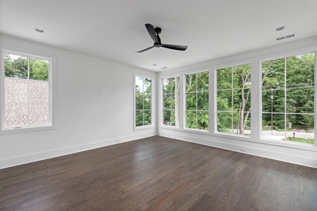 unfurnished room with dark hardwood / wood-style floors and ceiling fan