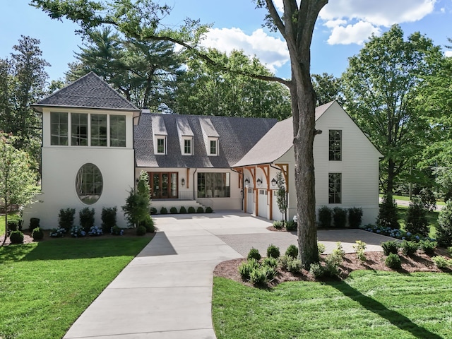 view of front of home with a garage and a front yard