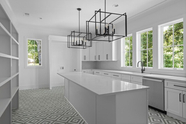 kitchen with stainless steel dishwasher, a kitchen island, tile floors, sink, and white cabinetry