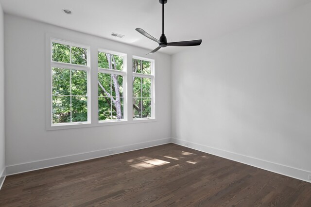 unfurnished room with ceiling fan and dark hardwood / wood-style flooring