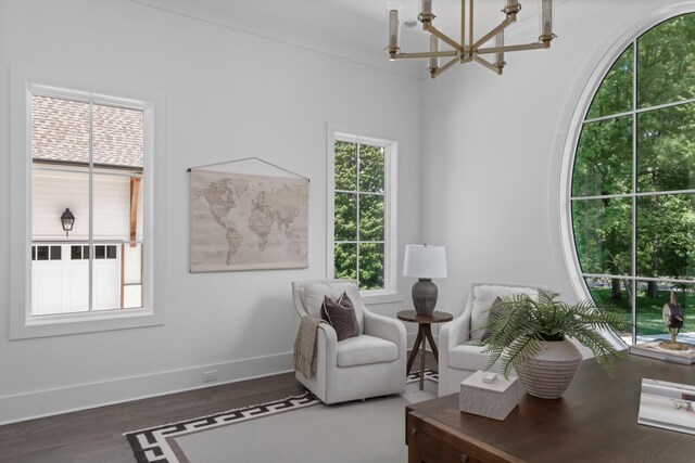 sitting room with hardwood / wood-style floors and a chandelier