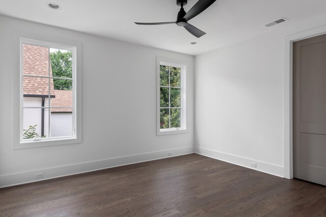 empty room with ceiling fan and dark wood-type flooring