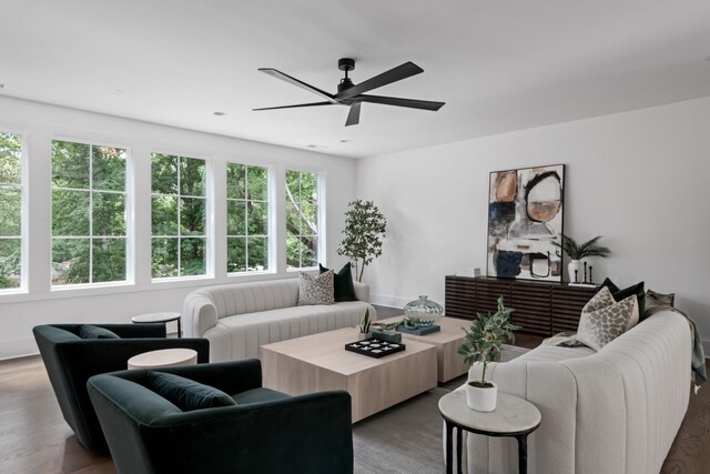 living room with dark hardwood / wood-style floors, plenty of natural light, and ceiling fan