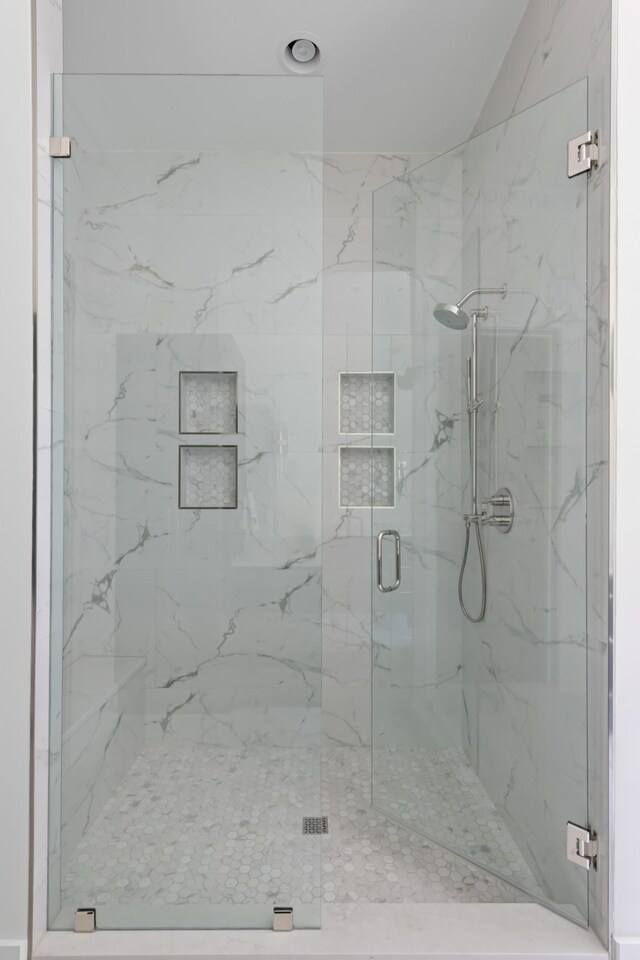 bathroom featuring a shower with shower door