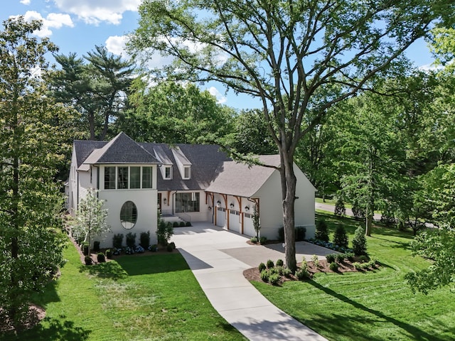 view of front of home featuring a garage and a front yard