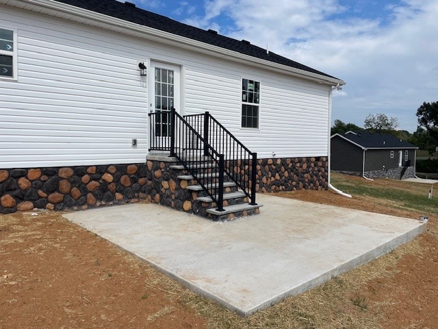 view of exterior entry featuring a patio area