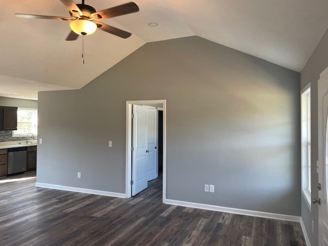 unfurnished living room featuring lofted ceiling, dark hardwood / wood-style floors, and sink