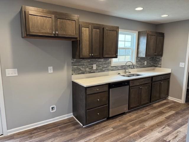 kitchen with sink, dark wood-type flooring, dark brown cabinets, and dishwasher