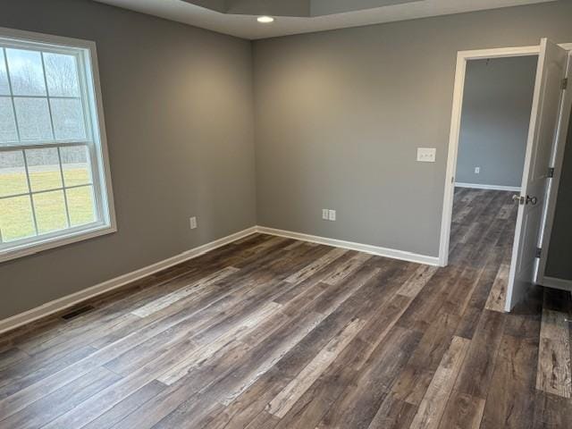 unfurnished room with dark hardwood / wood-style flooring