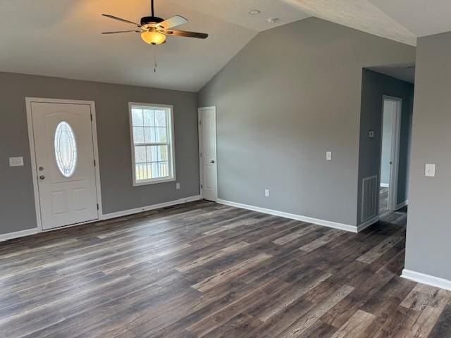 foyer entrance with dark wood-type flooring, vaulted ceiling, and ceiling fan