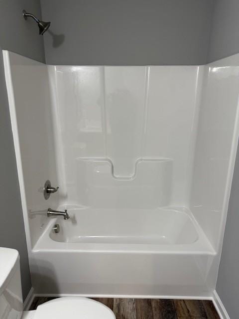 bathroom featuring hardwood / wood-style floors, toilet, and shower / bath combination