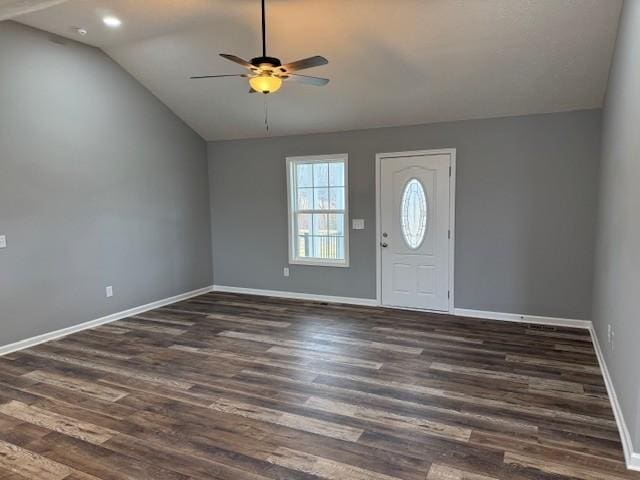 foyer entrance with dark hardwood / wood-style flooring, vaulted ceiling, and ceiling fan