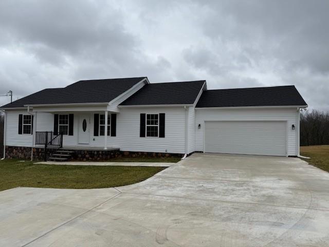 single story home with a garage and a front lawn