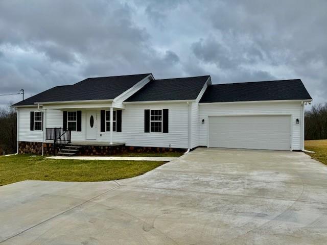 ranch-style house with a garage and a front lawn