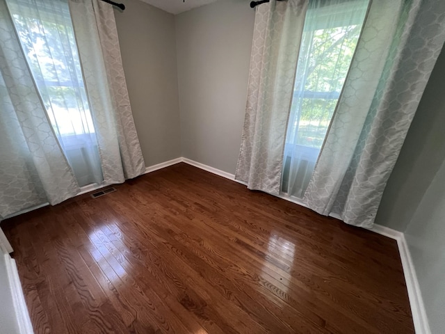 spare room with dark hardwood / wood-style flooring