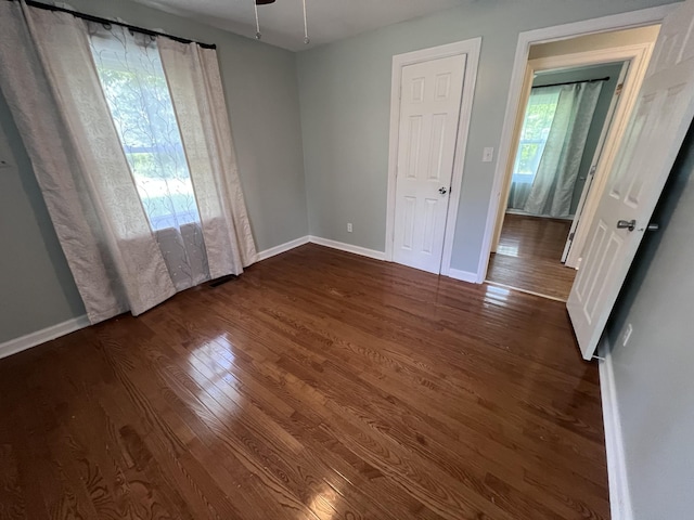 spare room featuring ceiling fan and dark wood-type flooring