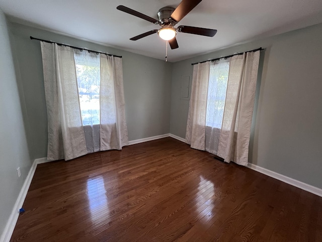 unfurnished room featuring ceiling fan and dark hardwood / wood-style flooring