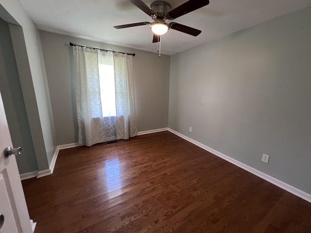 empty room with dark hardwood / wood-style floors and ceiling fan