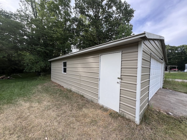 view of outbuilding with a yard and a garage