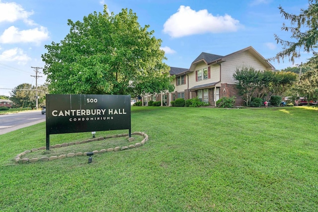 community sign featuring a lawn