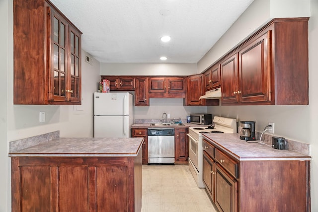 kitchen featuring sink, a textured ceiling, and appliances with stainless steel finishes