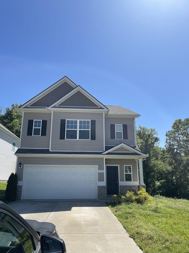 view of front of home with a front yard and a garage