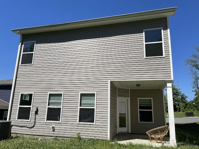 rear view of house featuring central air condition unit