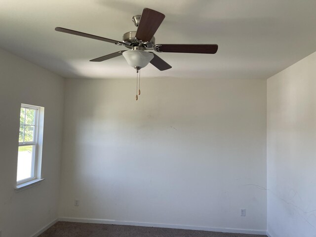 unfurnished room with carpet flooring and ceiling fan