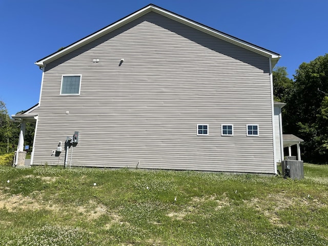 view of side of home with central AC unit