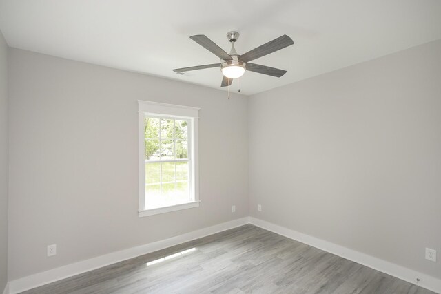 spare room featuring ceiling fan and light hardwood / wood-style flooring