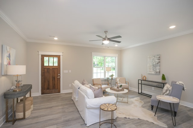 living room featuring ornamental molding, ceiling fan, and light hardwood / wood-style flooring