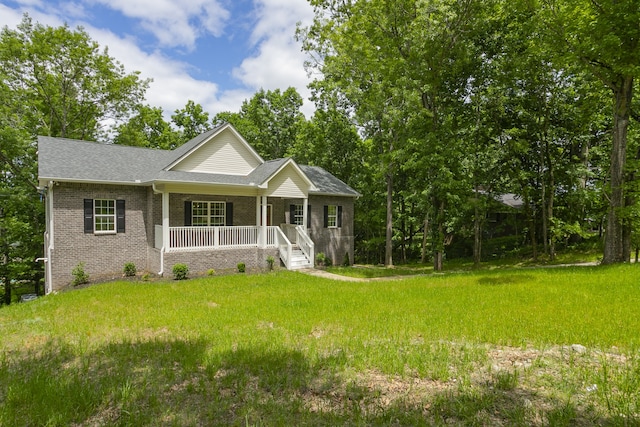 view of front of home with a front yard and covered porch